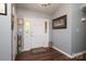 Inviting entryway featuring wood floors, neutral walls, and a stylish front door with decorative glass accents at 1730 Deer St, Charlotte, NC 28214