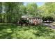 Quaint brick house nestled among mature trees, enhanced by a lovely green lawn and a welcoming facade at 1730 Deer St, Charlotte, NC 28214
