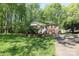 Charming single-story brick home with well-manicured lawn and lush landscaping, set amongst mature trees in a peaceful neighborhood at 1730 Deer St, Charlotte, NC 28214