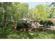 Charming single-story brick home with well-manicured lawn and lush landscaping, set amongst mature trees in a peaceful neighborhood at 1730 Deer St, Charlotte, NC 28214