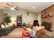 Inviting living space with a ceiling fan, brick fireplace, comfortable furniture and open flow to the dining area at 1730 Deer St, Charlotte, NC 28214
