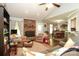 Comfortable living room featuring a vaulted ceiling, brick fireplace, and an open view to the dining area at 1730 Deer St, Charlotte, NC 28214