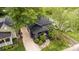 Aerial view showcasing the home's curb appeal, gravel driveway, and beautiful landscaping at 1824 Umstead St, Charlotte, NC 28205