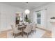 Open-concept dining room with pendant lighting, stylish table setting, and hardwood flooring at 1824 Umstead St, Charlotte, NC 28205