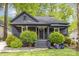 Inviting home with a classic front porch, beautiful landscaping, and freshly cut lawn at 1824 Umstead St, Charlotte, NC 28205