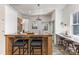 Bright kitchen featuring custom wood island, sleek countertops, bar stool seating and stainless steel appliances at 1824 Umstead St, Charlotte, NC 28205