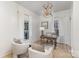 Bright home office space features hardwood floors, neutral furniture, lots of natural light and stylish decor at 1824 Umstead St, Charlotte, NC 28205