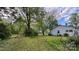 Large, grassy backyard with mature trees and a charming fence line, showcasing the property's outdoor space at 2118 Polkville Rd, Shelby, NC 28150