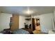 Simple bedroom featuring a bed, exposed wall, and view into the adjacent kitchen at 2118 Polkville Rd, Shelby, NC 28150