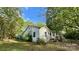 This home features white siding, mature trees, and a well-maintained lawn, creating a serene setting at 2118 Polkville Rd, Shelby, NC 28150