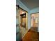 Hallway featuring a sliding wood door with glass panel and wood floors at 2118 Polkville Rd, Shelby, NC 28150