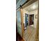 Hallway with hardwood-style flooring and a sliding wood framed glass panel door at 2118 Polkville Rd, Shelby, NC 28150