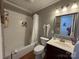 Well-lit bathroom featuring a shower-tub combo and ample counter space at 212 E Stewart Ave, Mooresville, NC 28115