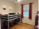 Bedroom showcasing a bunk bed, playful decor, and natural light at 212 E Stewart Ave, Mooresville, NC 28115