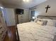 Bedroom features a black metal bed frame, TV, hardwood floors, and neutral walls at 212 E Stewart Ave, Mooresville, NC 28115