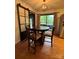 Dining area with hardwood floors, backyard view, and a stylish pendant light fixture at 212 E Stewart Ave, Mooresville, NC 28115