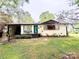 Charming single-story home with brick facade, mature trees, carport, and a cozy front porch at 212 E Stewart Ave, Mooresville, NC 28115
