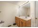 Bathroom featuring vanity with double sinks and well-lit mirror at 215 Raleigh Nw St, Concord, NC 28027