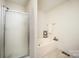 A bright bathroom features a glass door shower and a corner soaking tub with towel rack and amenities at 215 Raleigh Nw St, Concord, NC 28027