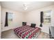 Bedroom with a geometric patterned comforter and wood-look flooring is well-lit by two windows and a ceiling fan at 215 Raleigh Nw St, Concord, NC 28027