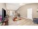 Spacious living room with stylish flooring, leading to a dining area with French doors at 215 Raleigh Nw St, Concord, NC 28027