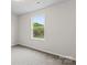 Light bedroom with soft carpet, view to a treed backyard, and ceiling light at 221 Century Dr, Salisbury, NC 28147