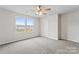 Light bedroom with soft carpet, double windows and ceiling fan at 221 Century Dr, Salisbury, NC 28147