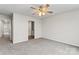 Bedroom features soft carpet, ceiling fan and view to the Primary bath and hallway at 221 Century Dr, Salisbury, NC 28147