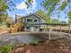 Home's back exterior with a wooden deck, carport, and a spacious asphalt parking area at 2222 Moose Rd, Kannapolis, NC 28083
