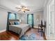 A bedroom is shown with a bed, an area rug, and two windows that provide natural light at 2222 Moose Rd, Kannapolis, NC 28083