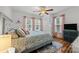 Cozy bedroom featuring a bed, nightstand, ceiling fan, and wood floors with an accent rug at 2222 Moose Rd, Kannapolis, NC 28083