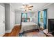 A well-lit bedroom is shown with a bed, area rug, 2 windows, and neutral colored walls at 2222 Moose Rd, Kannapolis, NC 28083