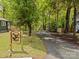 Scenic driveway leading to a home with a wooded backdrop and distinctive moose sign at 2222 Moose Rd, Kannapolis, NC 28083