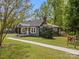 View of exterior of home showing large front yard and welcoming front porch at 2222 Moose Rd, Kannapolis, NC 28083