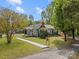 Beautiful home with a chimney, green exterior, landscaped yard, and charming front porch at 2222 Moose Rd, Kannapolis, NC 28083