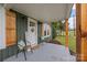 Cozy front porch with chairs, decorative door wreath, and natural wood pillar at 2222 Moose Rd, Kannapolis, NC 28083