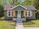 Inviting front porch with American flag, natural wood accents, and 'Welcome' sign at 2222 Moose Rd, Kannapolis, NC 28083