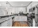 Updated kitchen with stainless appliances, granite countertops, and modern white cabinets at 2222 Moose Rd, Kannapolis, NC 28083