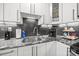Close-up view of kitchen area featuring stainless steel sink, granite countertops and subway tile at 2222 Moose Rd, Kannapolis, NC 28083