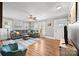 Open-concept living room with modern decor, wood floors, and seamless flow to dining area at 2222 Moose Rd, Kannapolis, NC 28083