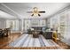 Comfortable living room featuring a ceiling fan, hardwood floors, and plenty of natural light at 2222 Moose Rd, Kannapolis, NC 28083