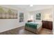 This bedroom is brightly lit and features two windows and wood-look flooring at 2403 Mary Ave, Gastonia, NC 28052