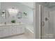 Bright bathroom featuring double sinks, soaking tub, and glass door shower at 2856 Huckleberry Hill Dr, Fort Mill, SC 29715