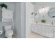 Bright bathroom features a toilet, double sink vanity, and decorative mirror at 2856 Huckleberry Hill Dr, Fort Mill, SC 29715