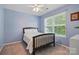 Comfortable bedroom features carpeted floors, a ceiling fan, and a large window at 2856 Huckleberry Hill Dr, Fort Mill, SC 29715