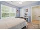 Cozy bedroom featuring neutral walls, plush carpet, and a bright window at 2856 Huckleberry Hill Dr, Fort Mill, SC 29715