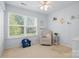 Bright bedroom with a comfortable chair and plenty of natural light at 2856 Huckleberry Hill Dr, Fort Mill, SC 29715