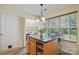 Bright breakfast area with an island, laundry nook, and a large window overlooking the backyard at 2856 Huckleberry Hill Dr, Fort Mill, SC 29715