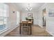 Sunlit dining room with wood-look floors, crown molding, and a classic chandelier at 2856 Huckleberry Hill Dr, Fort Mill, SC 29715