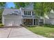 Charming two-story home with a well-manicured lawn, a two-car garage, and red window shutters at 2856 Huckleberry Hill Dr, Fort Mill, SC 29715